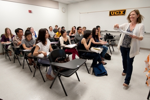 UCI Faculty member handing out papers to their students